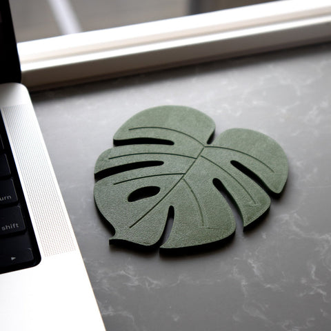 Leaf 3 of Coastera, a close look of the Monstera Plant Coaster on a tabletop